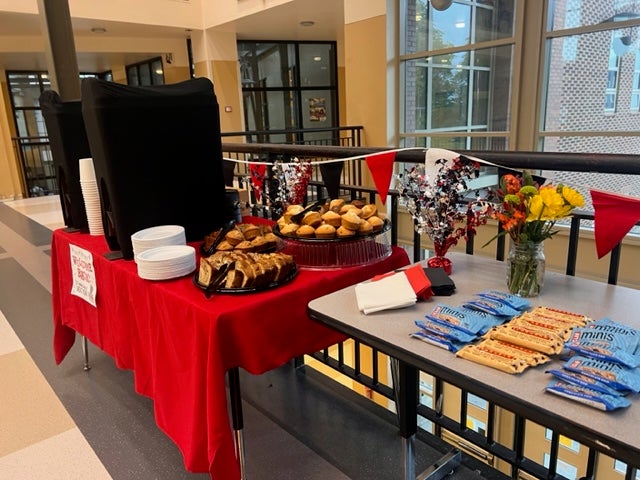Tables in the hallway welcoming back staff with lunch items.