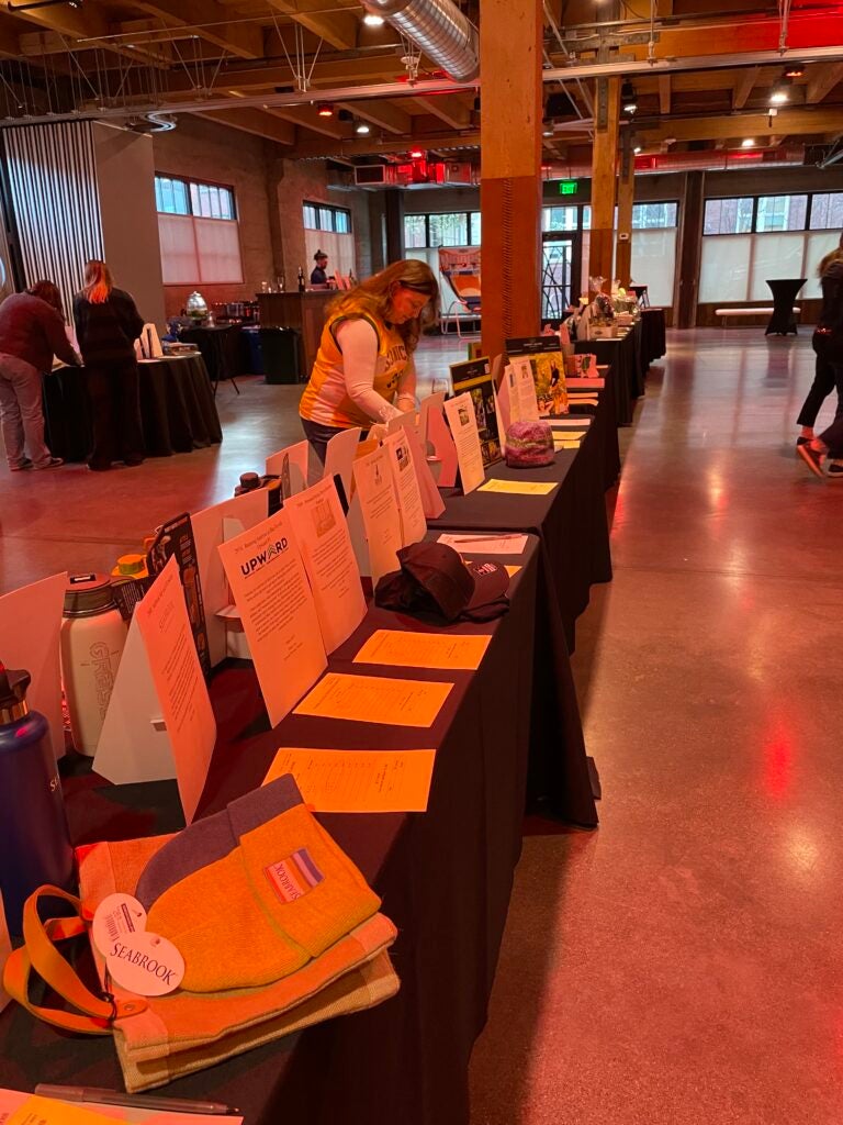 Long row of tables with sign up sheets on them