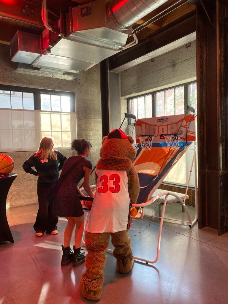 Bucky and 2 parents shooting hoops.