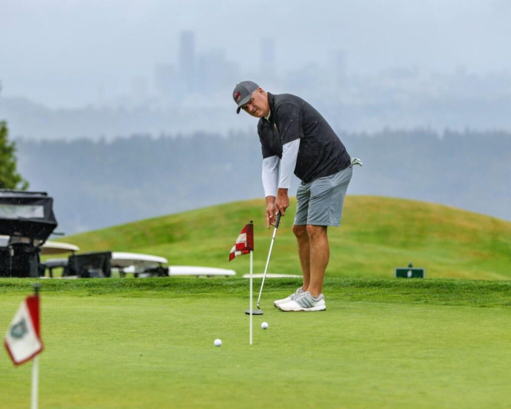 Golfer on putting green.