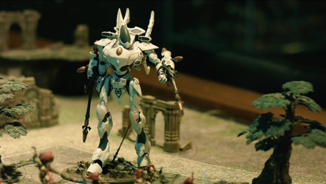 A robot character on sand. Waystone A Way Into Warhammer Film