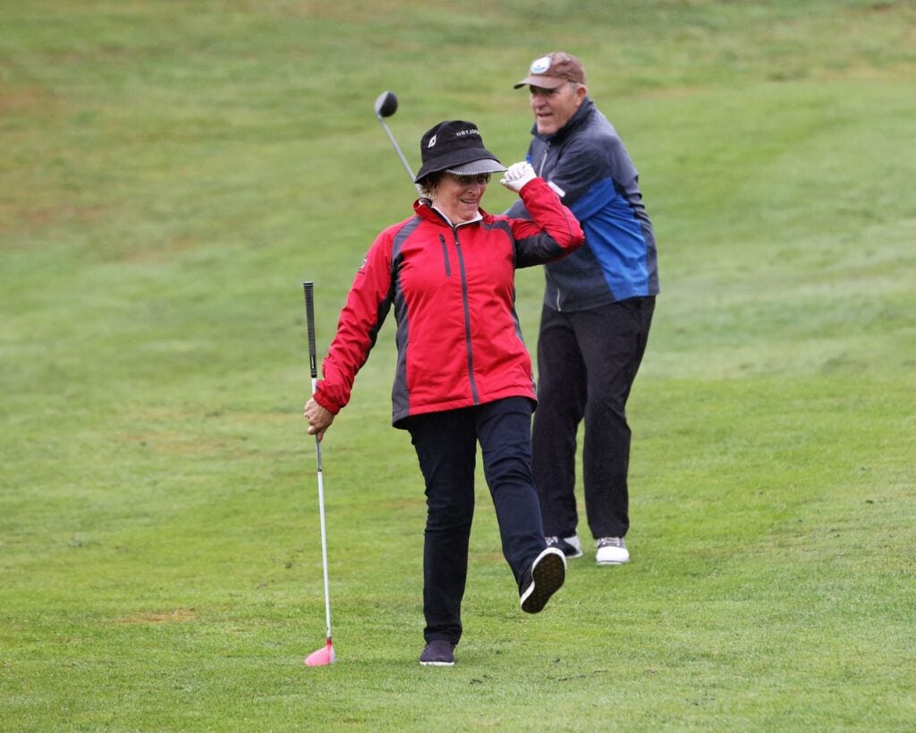 Linda Williams on Golf Course with another golfer.