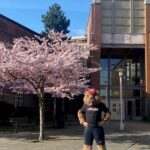 Bucky Beaver in front of Cherry Blooms Tree and Ballard HS.