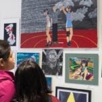 Adult and student looking at artwork at the Seattle Art Museum. Photo credit to Chloe Collyer
